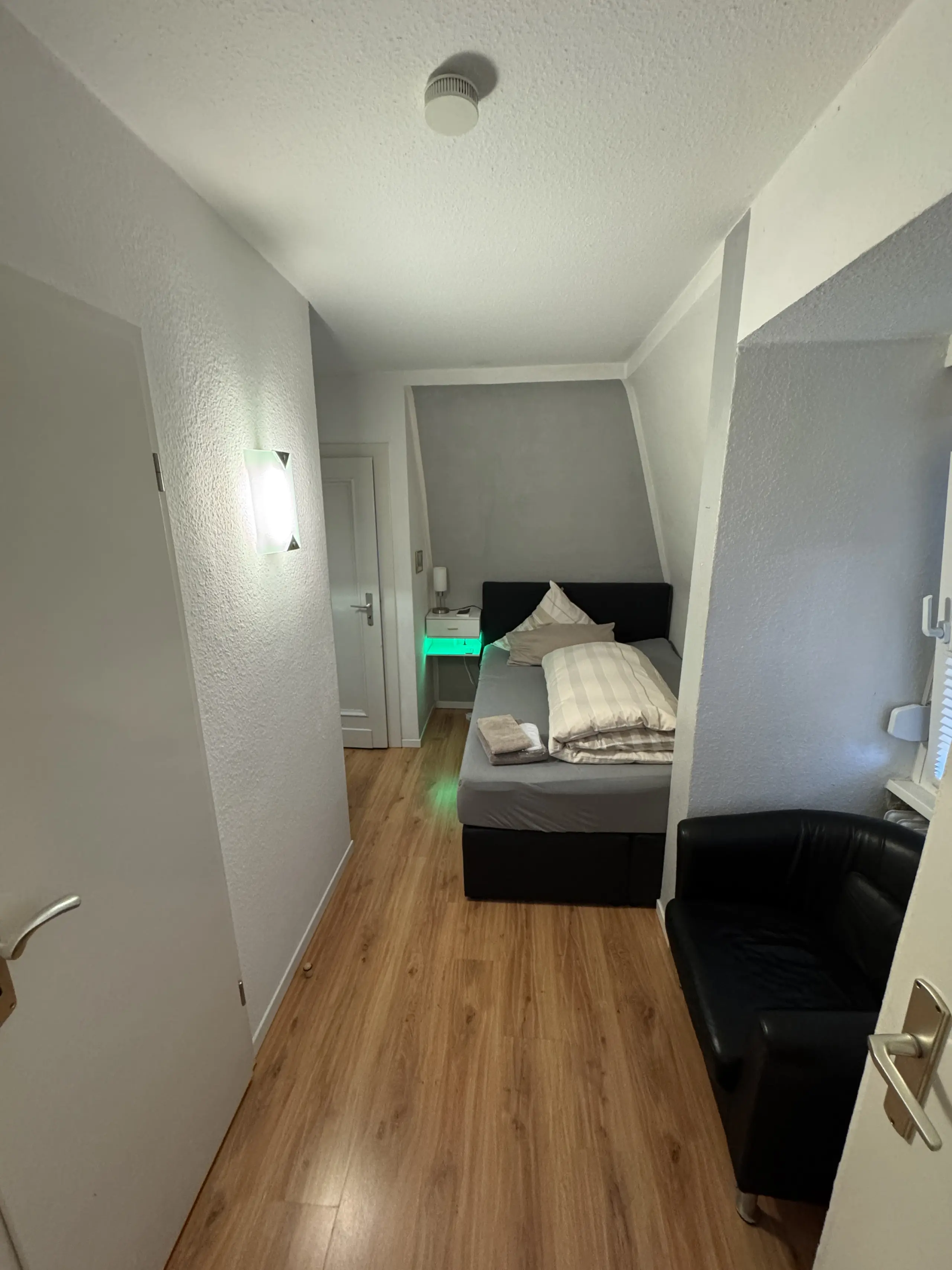 Schlafzimmer mit Bett und Nachttisch in der Ferienwohnung 4 in Bad Pyrmont